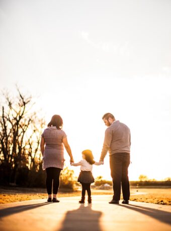 photo of family standing outdoors during golden hour