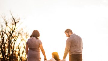 photo of family standing outdoors during golden hour