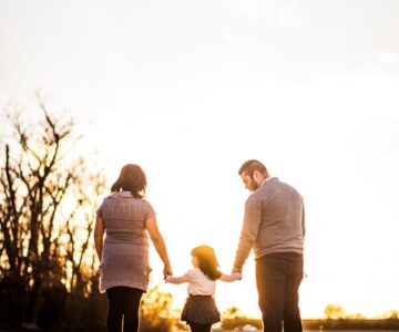 photo of family standing outdoors during golden hour