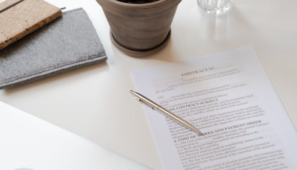 contract paper beside green potted plant