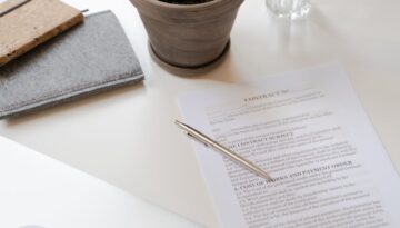 contract paper beside green potted plant