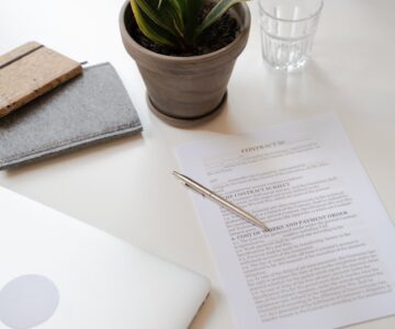 contract paper beside green potted plant