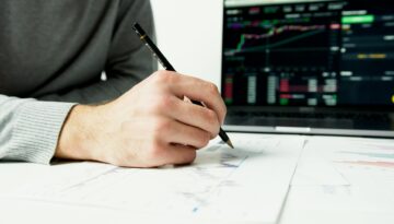person writing on white paper