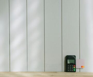 black and gray digital device on brown wooden table